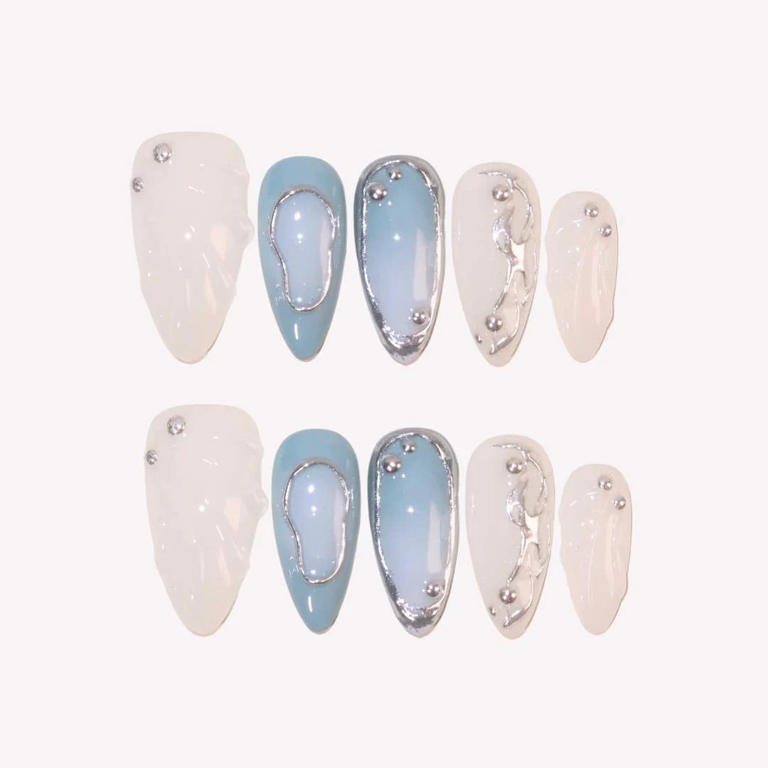 Set of nail art designs with white and light blue colors on a white background
